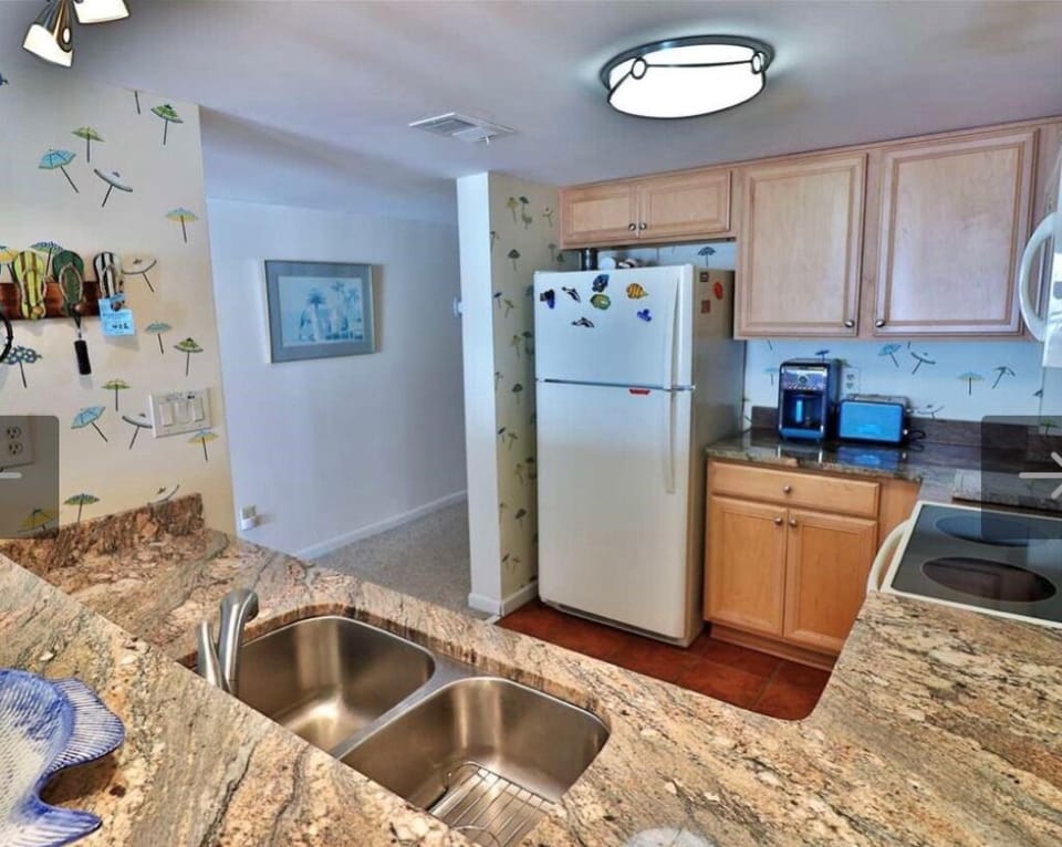 The modern kitchen has  granite countertops, an icemaker and a new dishwasher.