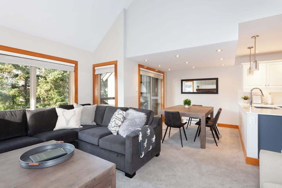- Spacious Whistler living and dining area with forest views  
- Open layout perfect for families or group retreats  
- Cozy seating and warm lighting for relaxing evenings  

