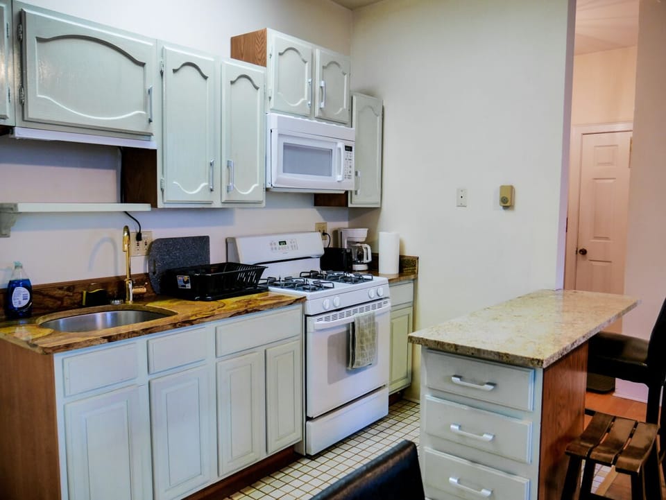 Kitchen with breakfast bar and granite countertops