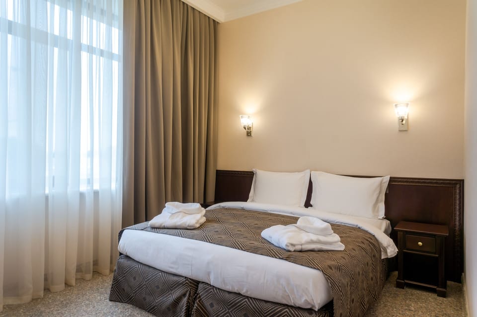 Standard Double Room | Minibar, in-room safe, desk, blackout drapes