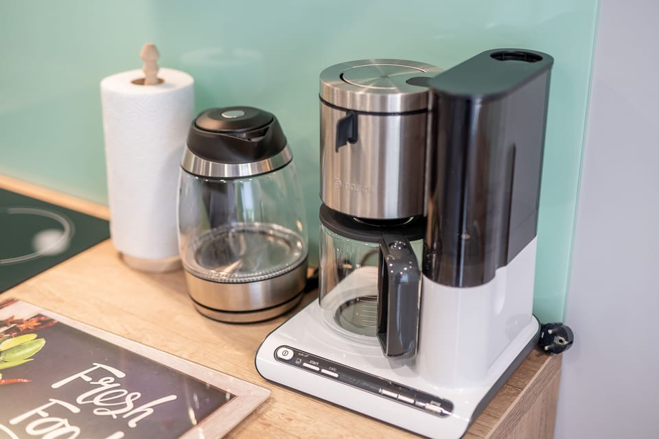 Fridge, coffee/tea maker, electric kettle, cookware/dishes/utensils