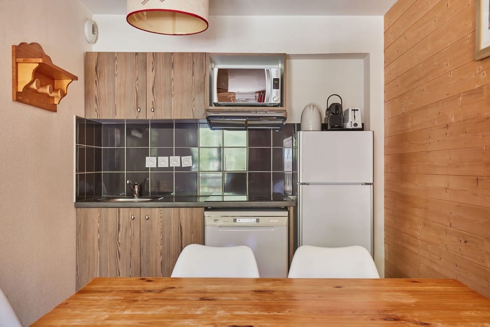 Kitchenette with fridge and microwave beside the dining table