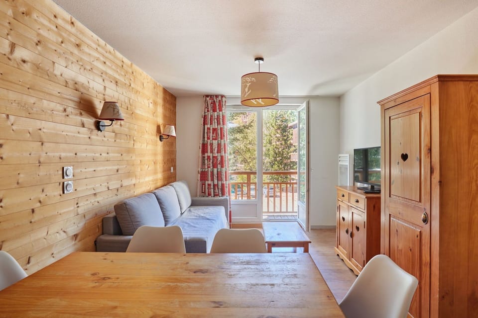 Living area with a wooden feature wall and sofa bed