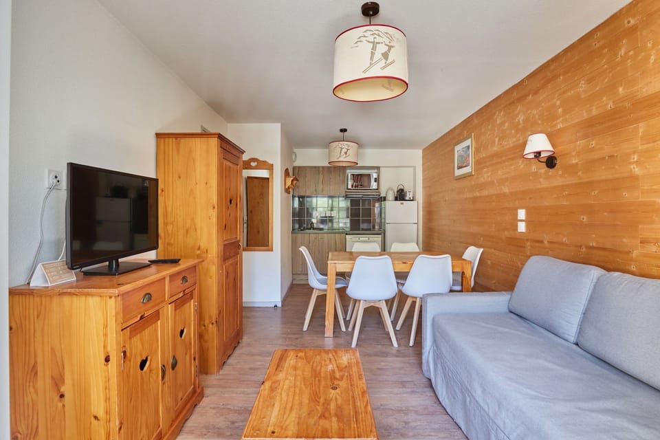 Living area with a sofa and light wooden furniture