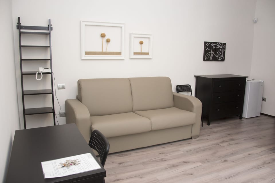 Quadruple Room | Living area | Flat-screen TV