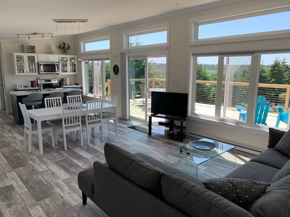 The living room features 9 foot ceilings, giant windows, is flooded with natural light and has direct access to the deck. There is also satellite TV and satelite internet.