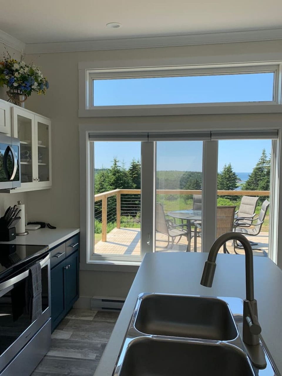 Enjoy ocean views and access to the spacious sundeck from this well-equipped kitchen with stainless steel appliances