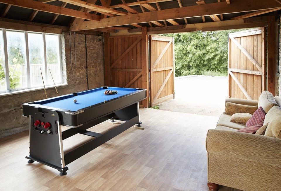 Games room with fridge, pool table, dart board (please bring your own darts), television and comfy chairs