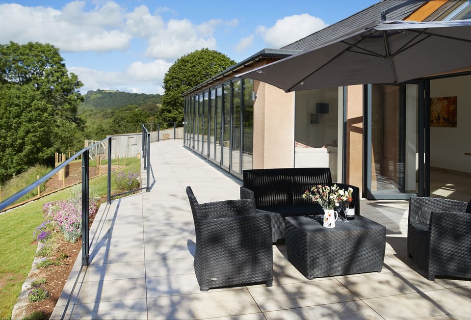 A staggering 16 metres of bi-folding doors opening out to a tiled balcony overlooking the beautiful river