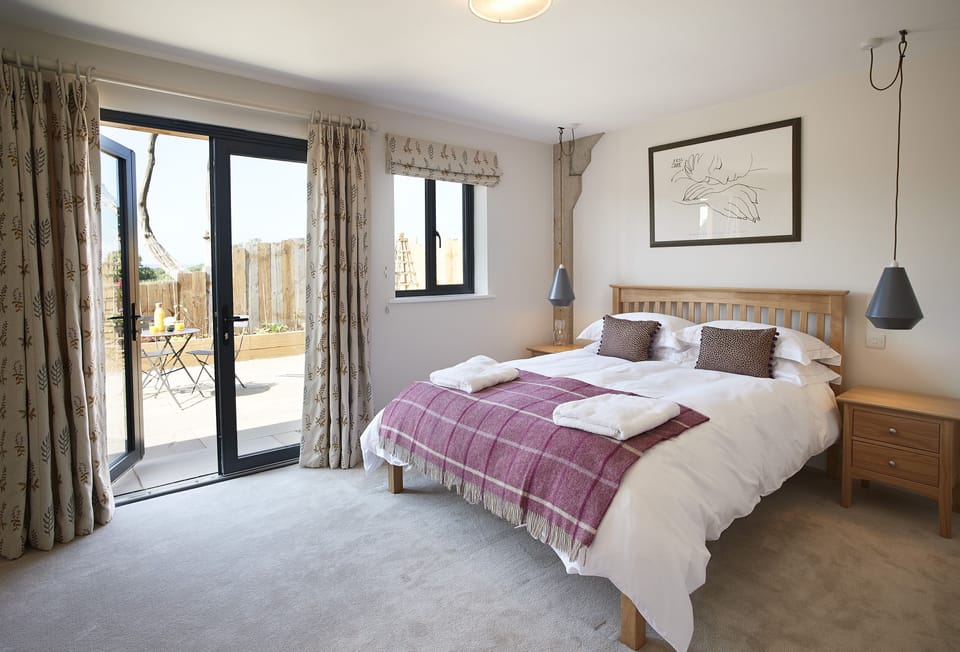 Ground floor: Bedroom two with a king-size bed, en-suite shower room and french doors leading to the terrace