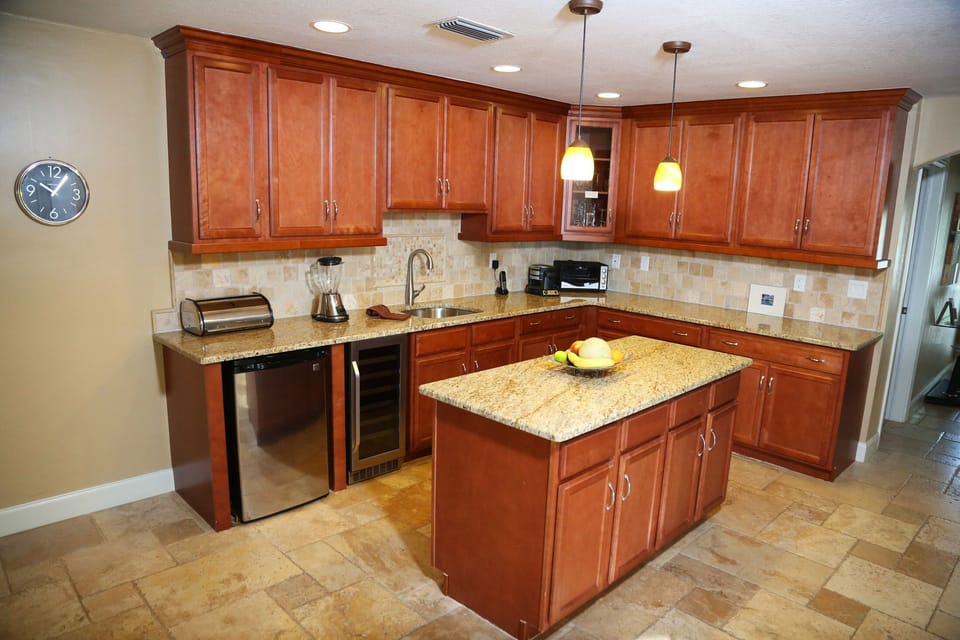 separate kitchen island with sink, wine cooler and additional fridge