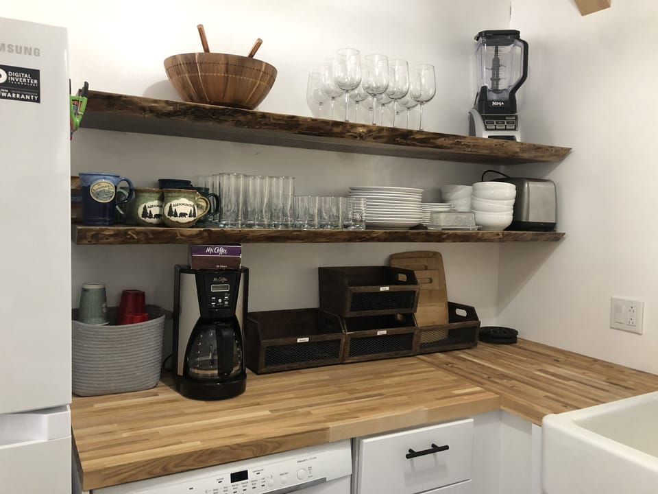 Kitchen.  Butcher block counter tops.  Custom live / raw edge floating shelves.