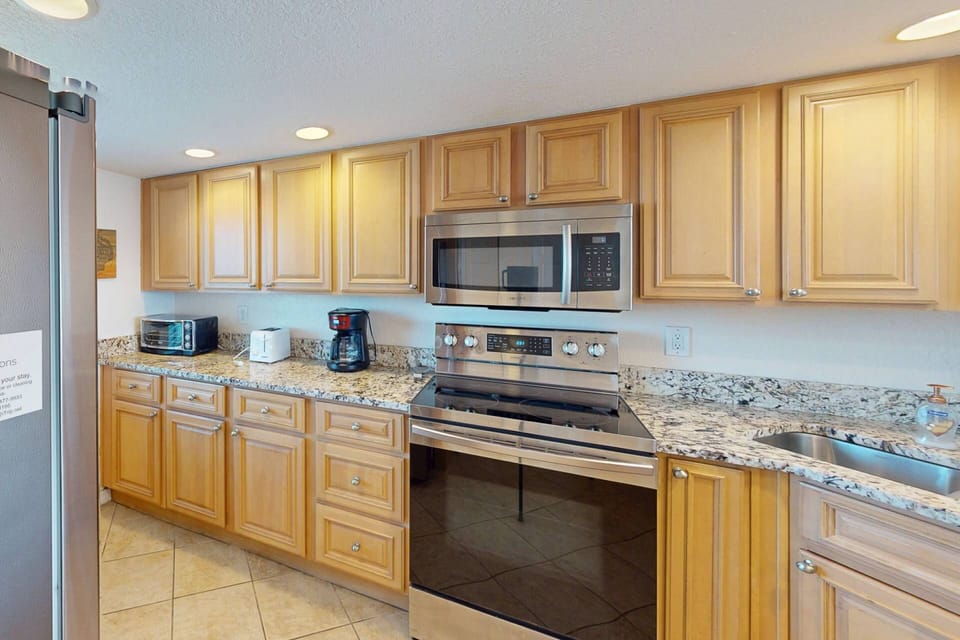 Granite counter top and stainless steele appliances in a well equipped kitchen for all meal preparation needs.