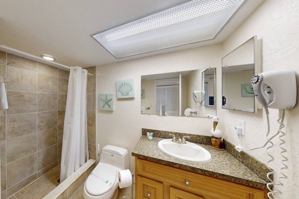 Guest bathroom with tiled walk-in shower.