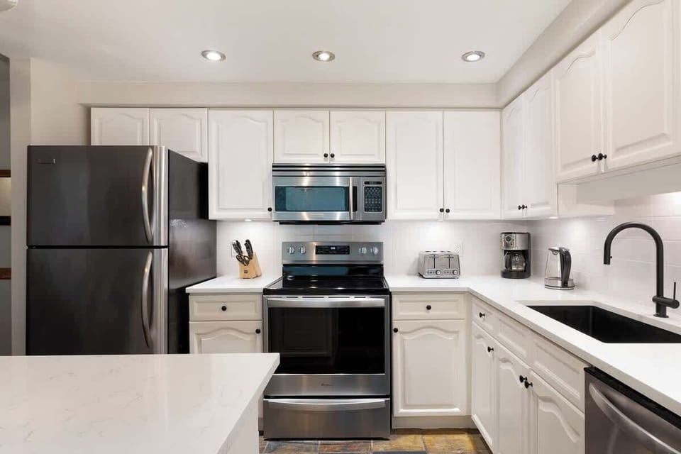 - Modern kitchen with sleek stainless steel appliances  
- Fully equipped for cooking your favorite mountain meals  
- Bright space with quartz counters and functional layout  
