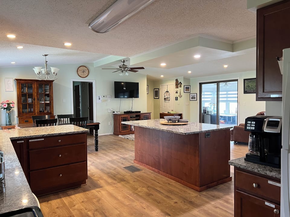 Open space - from kitchen to dining to living area - with view of the lake