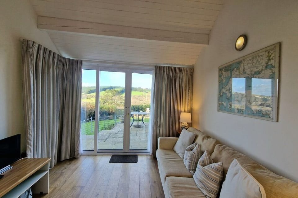 living area with large sliding doors leading out onto the sunny patio