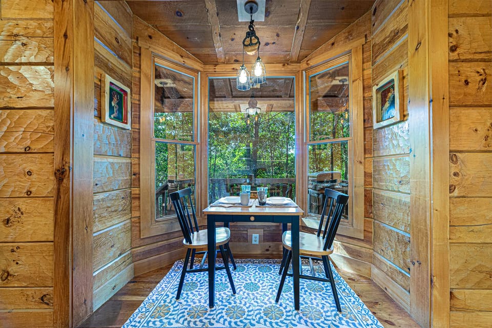 Breakfast nook overlooks the woods and deck