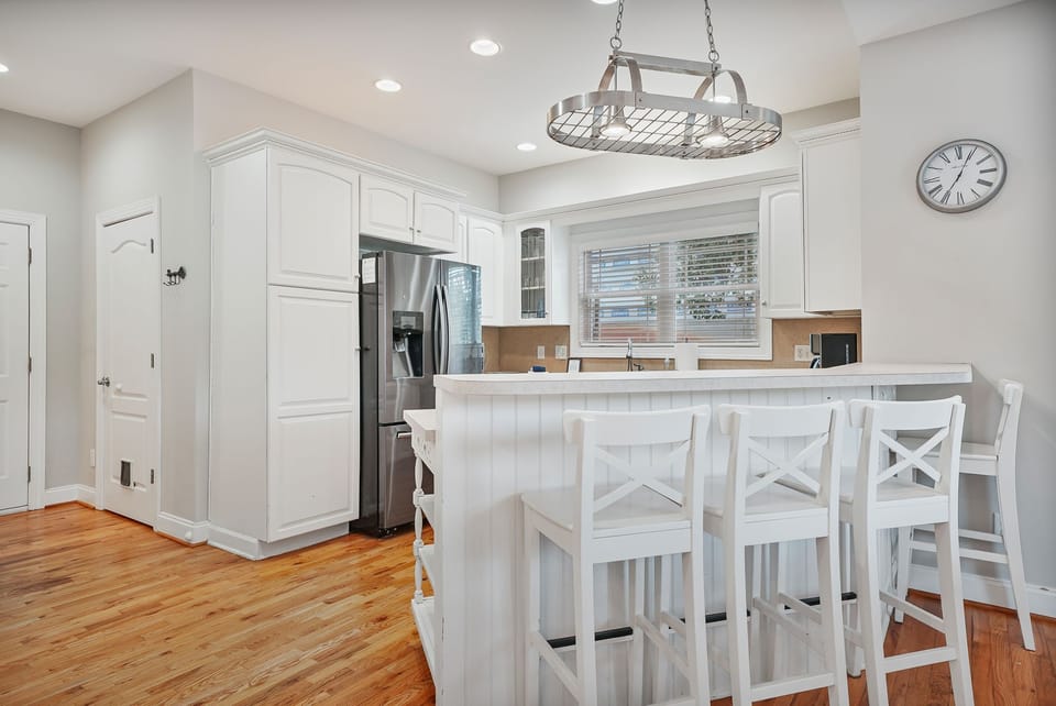 Fully stocked kitchen with seating for three.