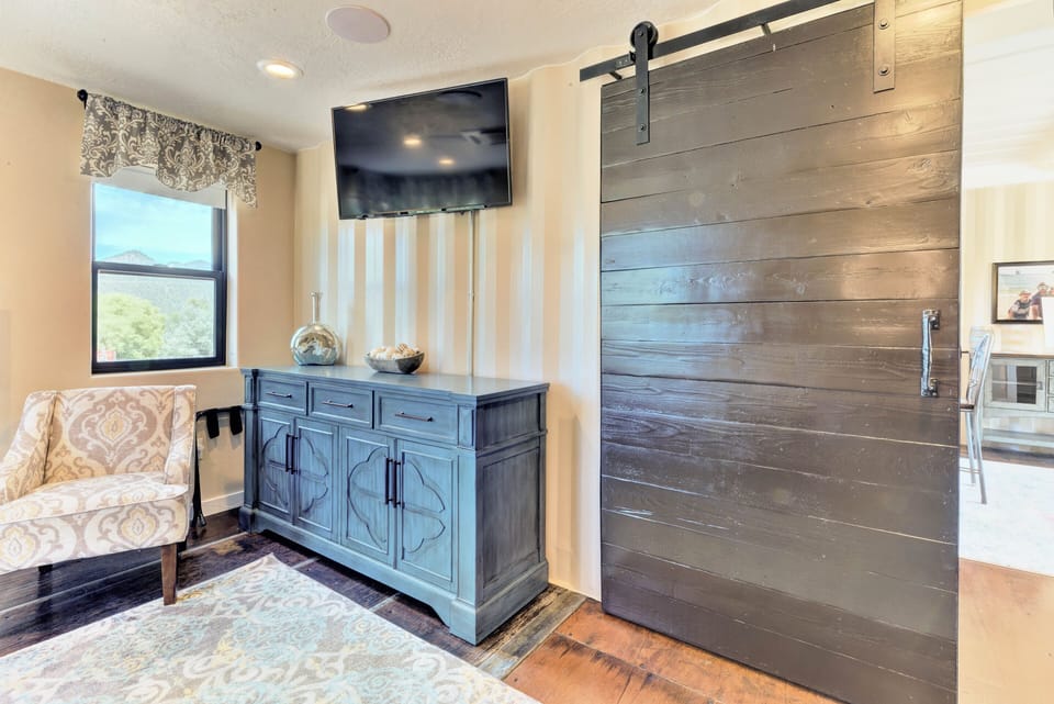 Romantic master suite and tranquil sitting area, tv and exquisite farm door. 