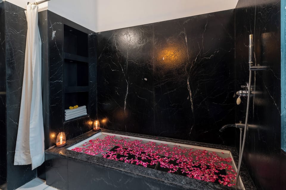 Deluxe Room, 1 Bedroom | Bathroom | Shower, free toiletries, hair dryer, slippers