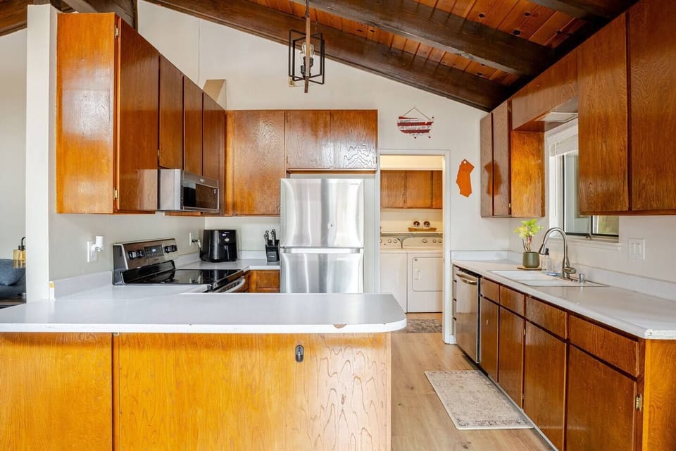 Fully stocked kitchen with stove, dishwasher and fridge