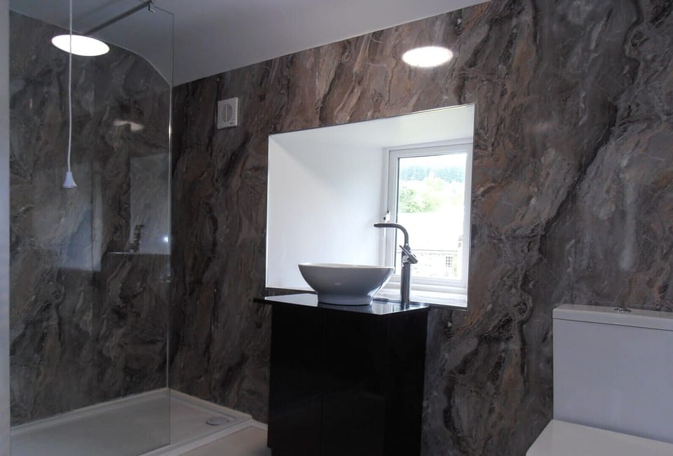 luxury bathroom with modern fittings and walk-in electric shower area