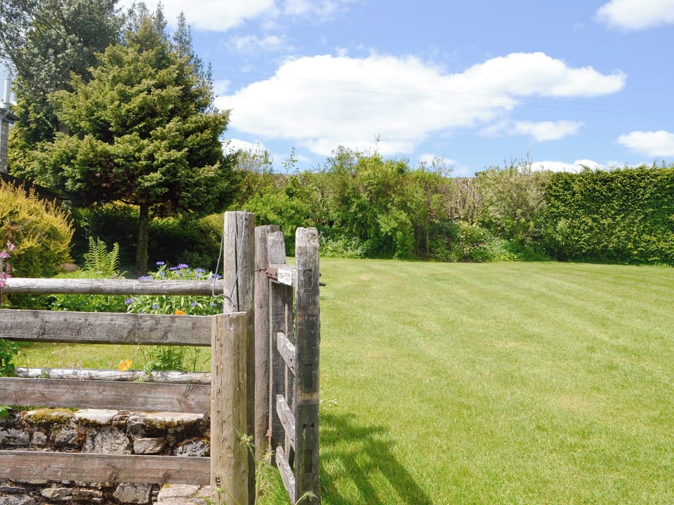 Enclosed lawned garden | Mountain View - Cefncoedbach Farm, Sarnau, near Brecon
