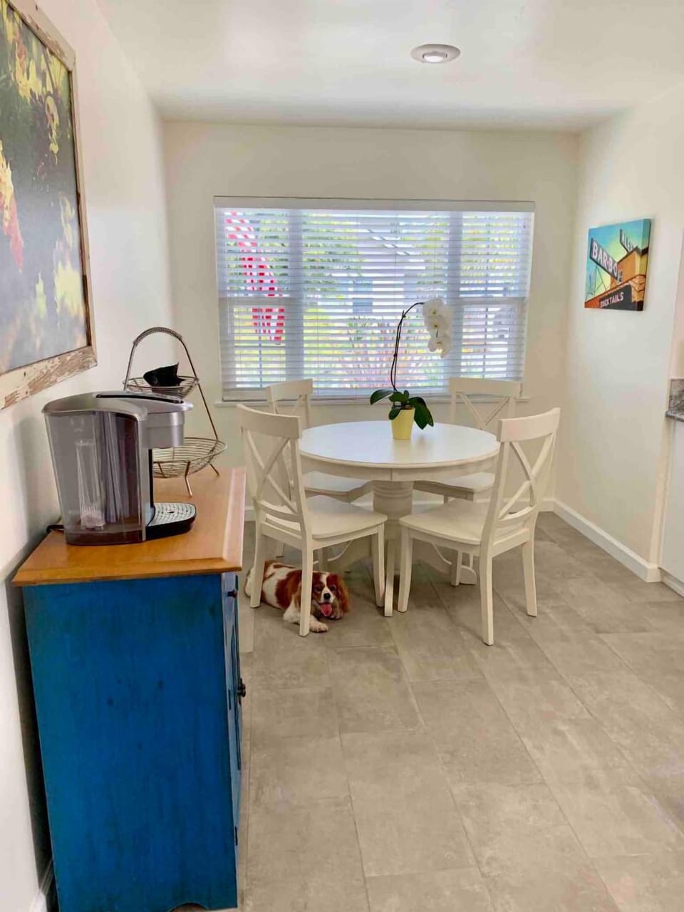 Dining area in the kitchen.  New floor tile, local artwork.