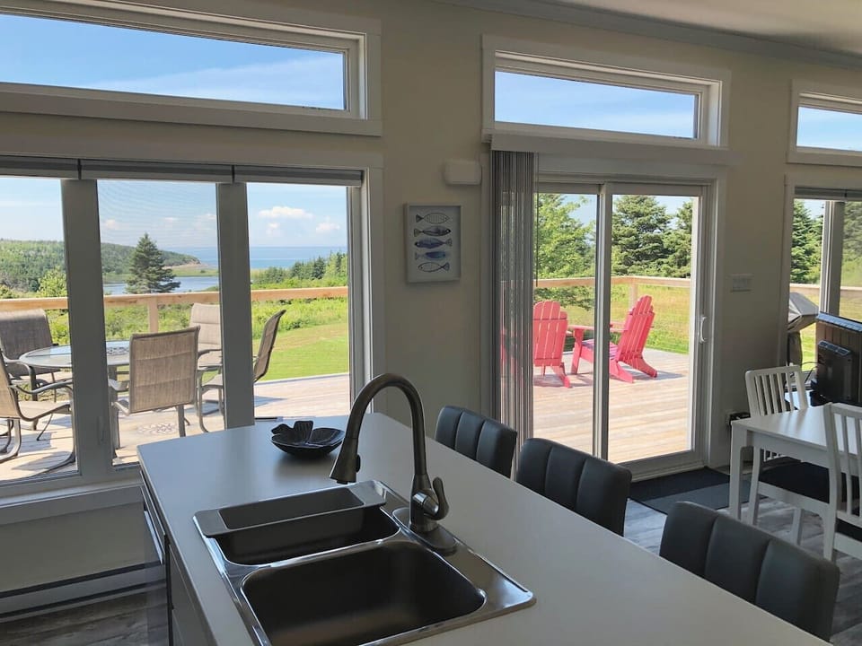 Enjoy ocean views and access to the spacious sundeck from this well-equipped kitchen with stainless steel appliances