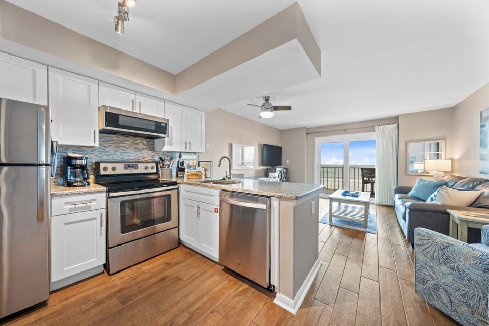 Your open kitchen flows seamlessly into the living space, where you can cook breakfast while enjoying ocean views through the sliding doors.