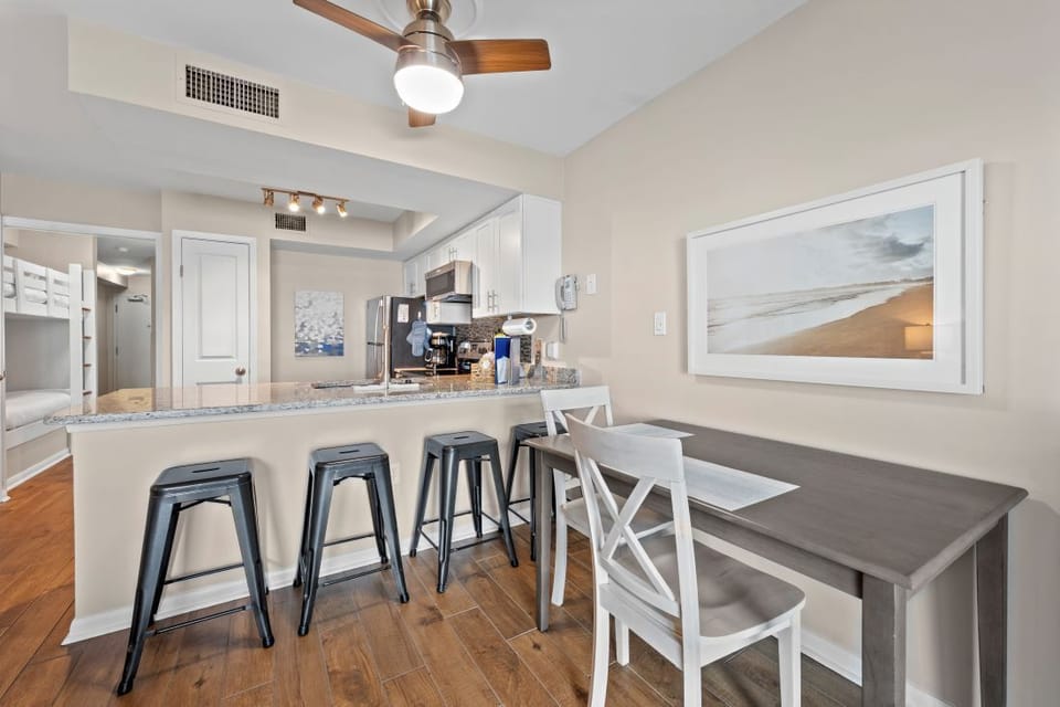 Your open kitchen invites you to prepare coastal meals while chatting with loved ones at the breakfast bar.