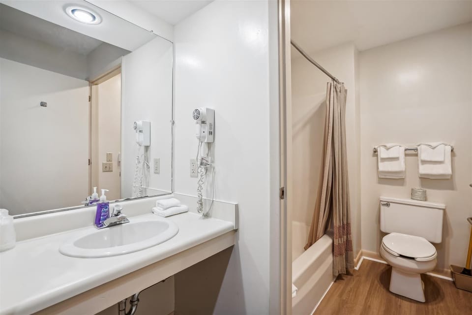 Full sized bathroom with a bathtub/shower combination.