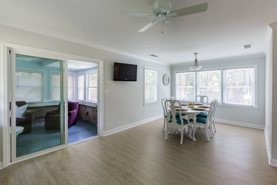 Dining area with sunroom off to the left with a pull out couch.