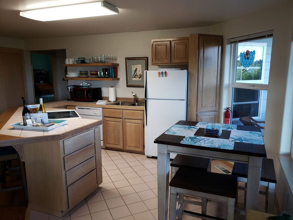 Kitchen with all appliances, pub dining and bar seating.
