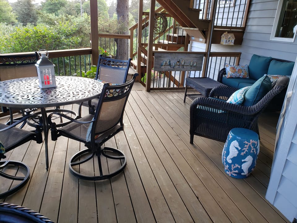 Spacious deck with comfortable seating and outdoor dining.