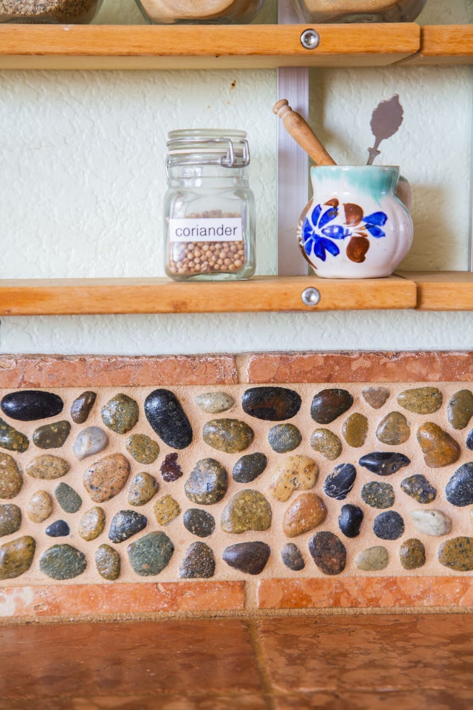 The kitchen has these pebbles from around the world, carefully selected to fit this home.