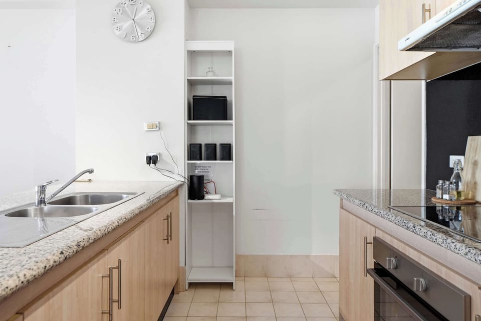 Whip up your favorite meals with the oven, cooktop, microwave, double sink, and ample prep space in this clean, contemporary kitchen.