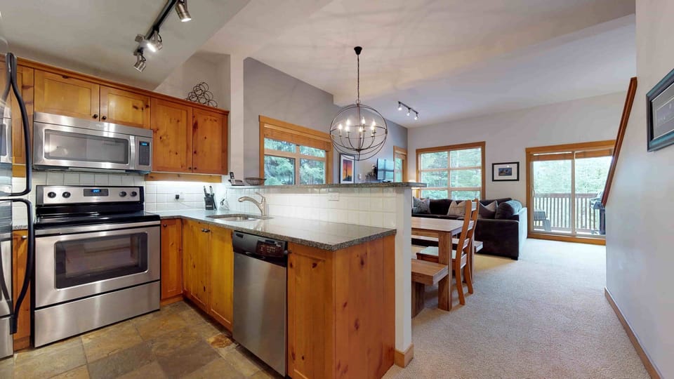 - Open-plan living and dining area with rustic wood accents  