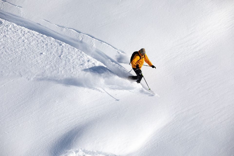 A skier carves through deep powder on the slopes of Vars, one of the Southern French Alps' most snow-sure ski resorts.