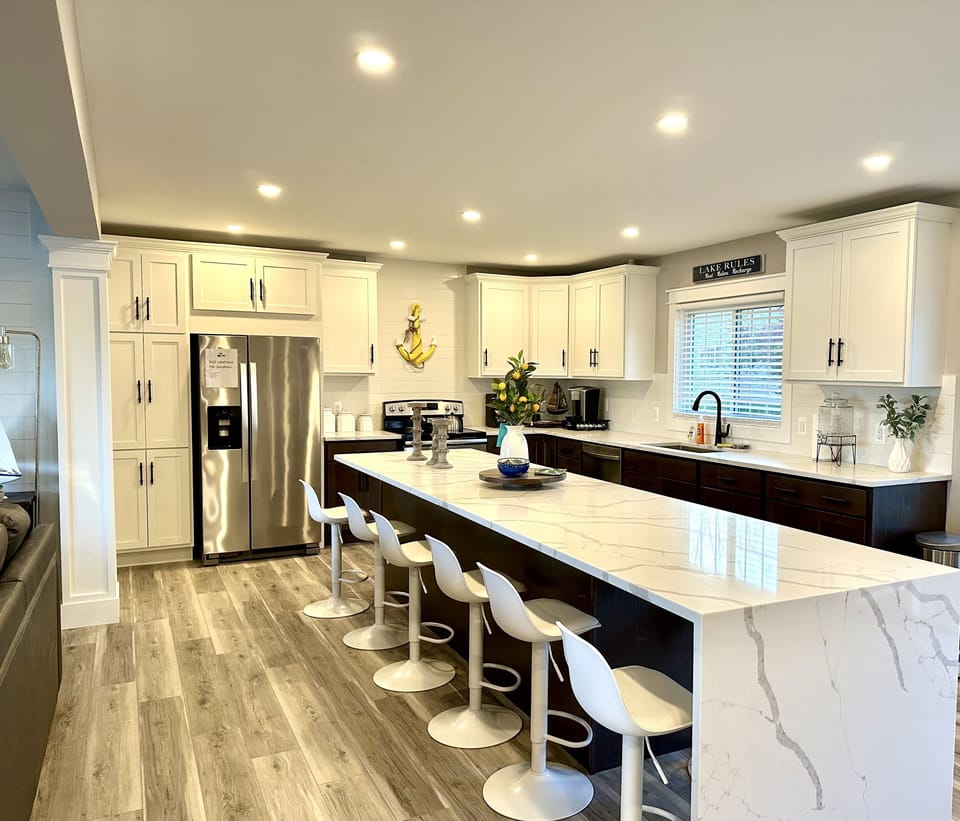 Spacious gourmet kitchen with seating for 8 around the waterfall granite island.