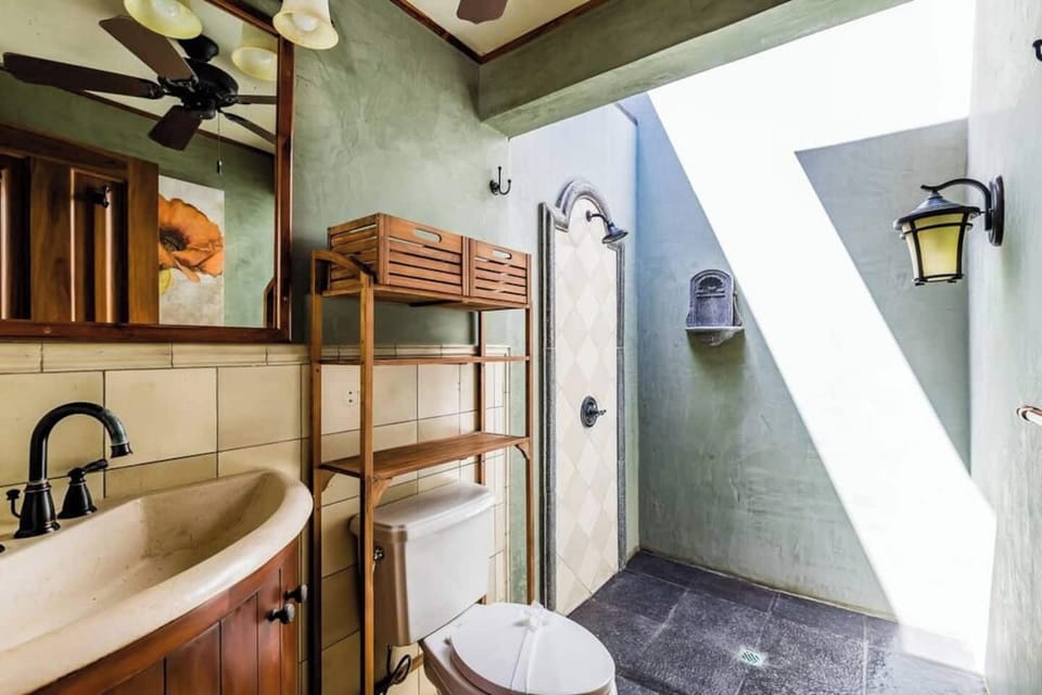 Stylish guest bathroom #3 with contemporary design, perfect for unwinding and enjoying all the comforts of this Tamarindo luxury villa.