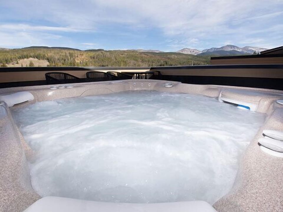 Soak in the bubbling hot tub while soaking up breathtaking mountain views and endless blue skies above.