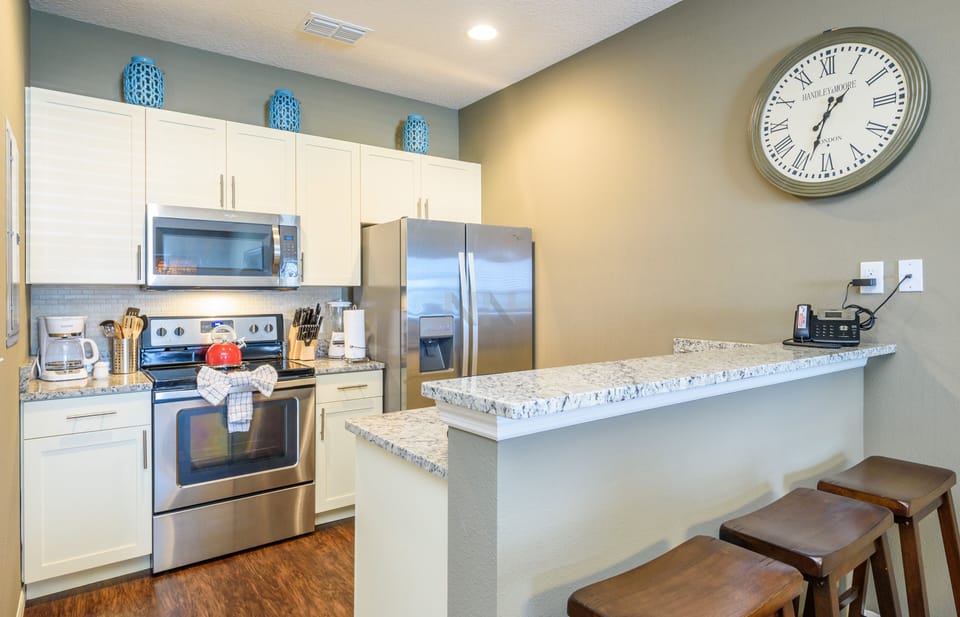 Well-equipped kitchen with bar stools.