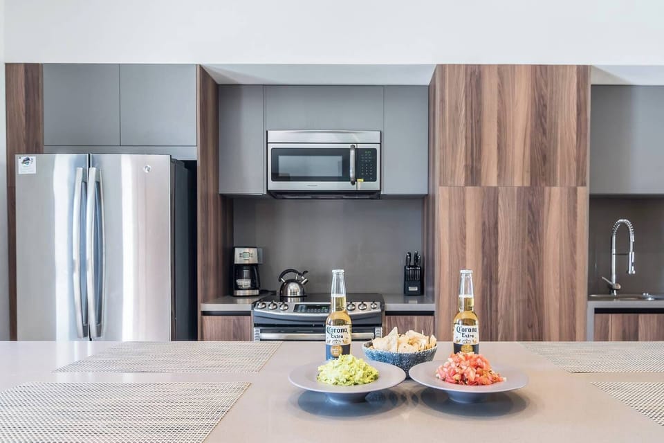 Fully equipped kitchen and bar with seating  for 4
