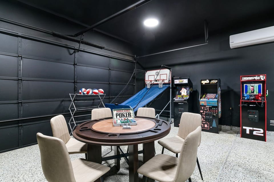 This game room features a large variety of arcades, Pop-A-Shot, Skeeball, a large flat-screen TV, and a poker table!
