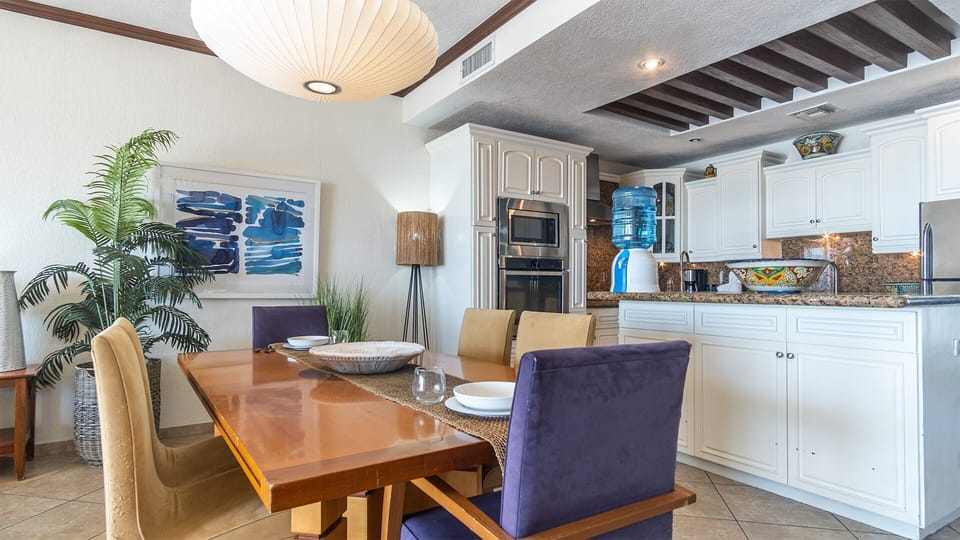 Dining table for six, leading into the kitchen.