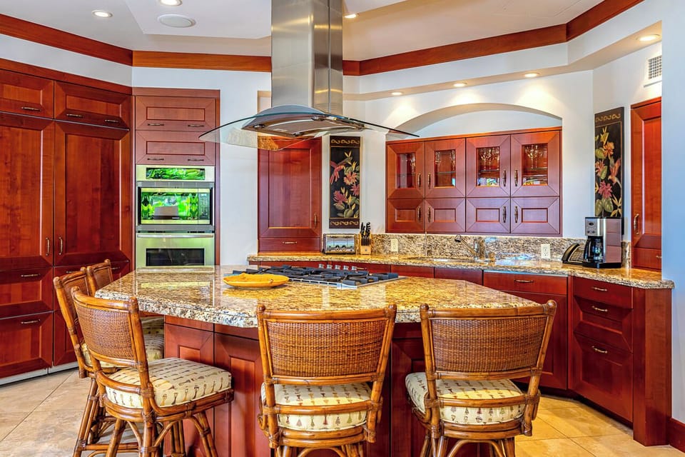 Your gourmet kitchen features stunning granite countertops, rich wood cabinetry, and a spacious island perfect for meal prep or casual dining with friends and family.
