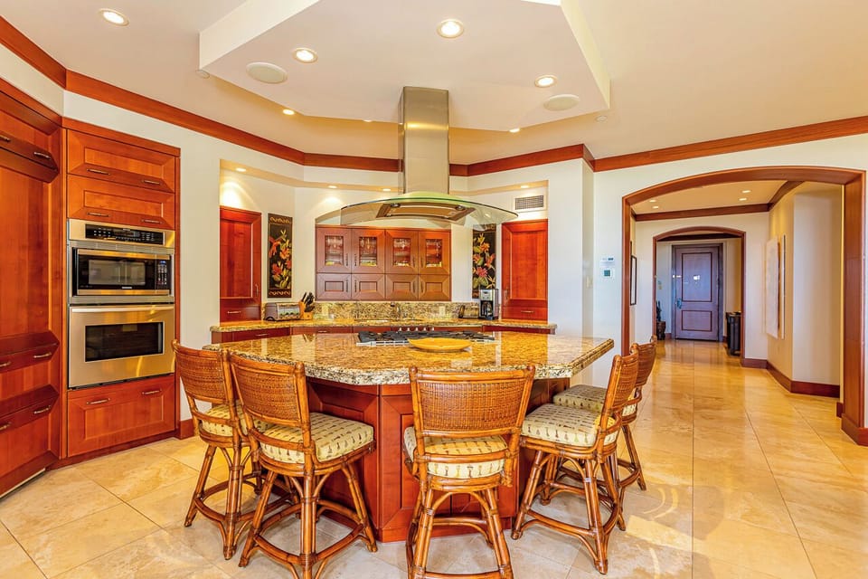 You'll love the chef's kitchen with its granite island, top-tier appliances, and elegant wood cabinetry—perfect for preparing meals together while you soak in the warmth of the space.
