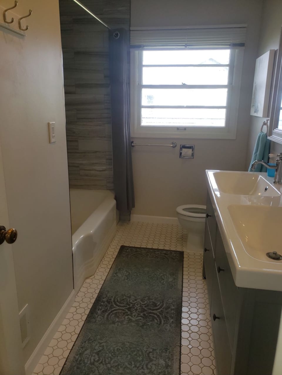 Main Bath found between bedrooms. Double sinks and shower in bathtub